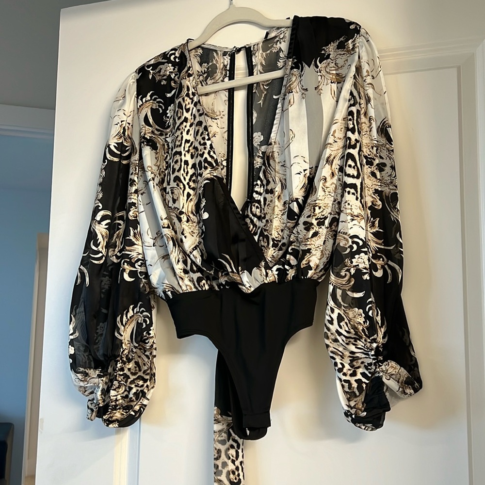 Cute open back body suit  blouse.